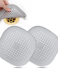 Square Silver Grey Hair Drain Catcher With Strong Suction Cup, Easy Peasy Shower Sink Filter That Kicks Clogs To The Curb seen near drain.