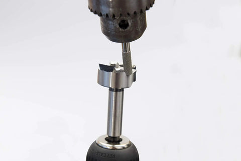 Pro Grade Forstner And Hinge Boring Bit Sharpener showcasing sharpener attachment to a drill bit, designed for wood drilling precision.