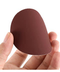 Top 100 Piece 3 Inch Sandpaper Discs With Super Grippy Backing Pads For Metal Wood And Plastic Polishing, showing brown sandpaper held in hand.