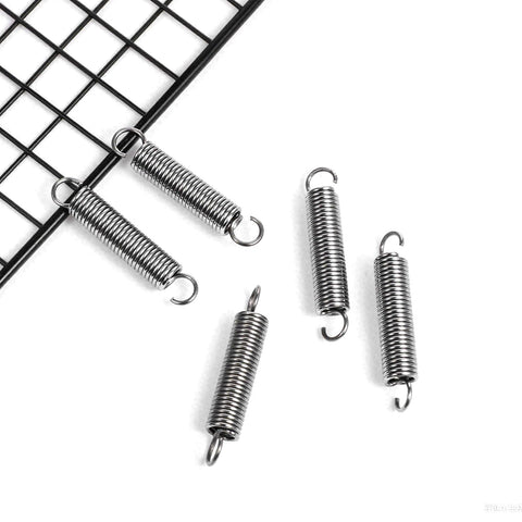Durable Stainless Steel Extension Springs With Dual Hook Ends, 2 Inch Length, 0.35 Inch Outer Diameter displayed on grid surface