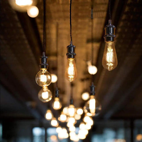 Pendant lights hang on braided cords, part of Three Light H System Track Mini Pendant Kit In Pearl Black Finish With Rose Braided Fabric Cord