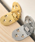 Gold and silver folding table hinges, 180 degree zinc alloy hardware on wood and white surfaces, part of 4 Pack Small Folding Table Hinges 180 Degree Zinc Alloy, Rust Resistant Gold Hardware For Cabinets, Sewing Machines, And Furniture, Heavy Duty, Easy Install, Durable Metal Mounts.