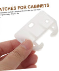 Hand holding a piece from the 12 Piece Plastic Drawer Latch Kit Sliding Rails For Kitchen Cabinets And Dressers.