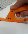 Close-up of Totally Rock Solid Bi Directional Safety Knife With Slick Retractable Blade and Ergonomic Handle in use cutting vinyl.