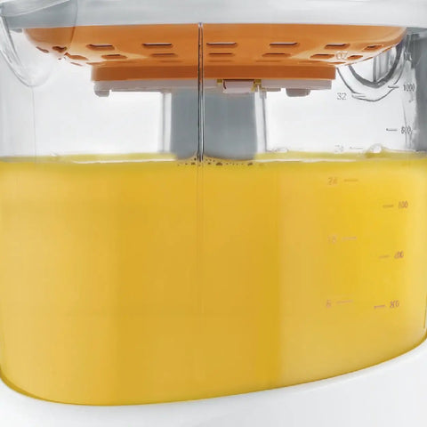 Side view of Electric Citrus Juicer With 32 Ounce Pitcher No Fuss Pressure Activated Adjustable Pulp Control filled with juice