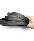 5m High Density Black Braided Carbon Fiber Cable Sleeving held in hand, showcasing flexible design for electronics automotive projects
