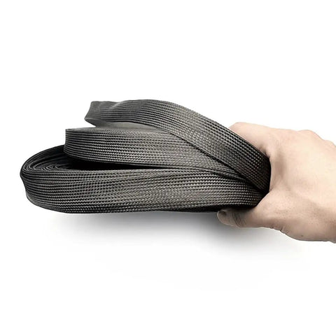 5m High Density Black Braided Carbon Fiber Cable Sleeving held in hand, showcasing flexible design for electronics automotive projects