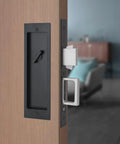 Modern Pocket Door Hardware Set With Privacy Lock, Finger Flush Pulls And Soft Close, installed on a wooden door.