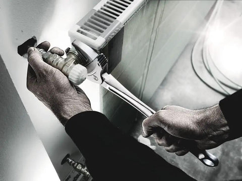 Joker XXL Self Setting Adjustable Wrench Auto Grip for Hex Fasteners in use on a metal pipe, showing firm grip on hex fitting.