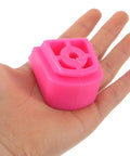 Universal Skate Brake Block For Roller Skates And Inline Pads in pink, shown on a hand for size reference.