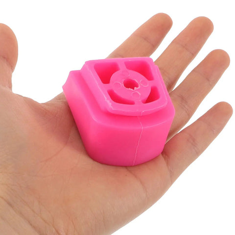 Universal Skate Brake Block For Roller Skates And Inline Pads in pink, shown on a hand for size reference.