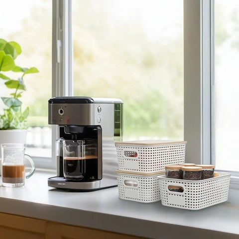 Three Six Pack Stackable Plastic Storage Bins With Lids And Bamboo Lid near a coffee maker on a kitchen counter.