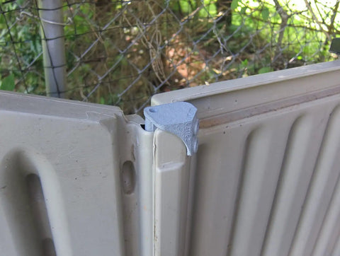 Hella Tough Steel Core Left Replacement Hinge For 6X5 Resin Shed Door Slide Lid mounted on resin lid showing metal reinforcement.
