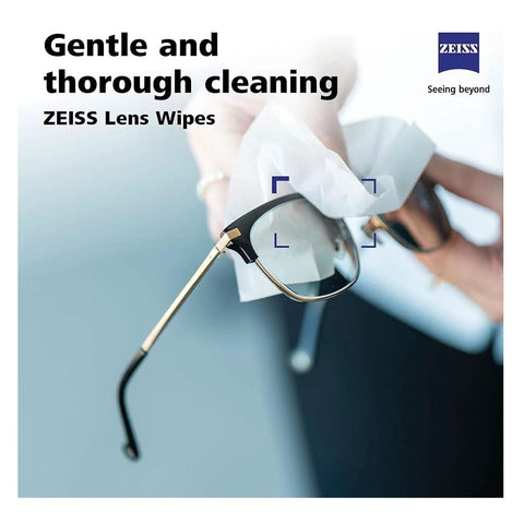 Zeiss Lens Wipes 120-pack; close-up of eyeglasses being wiped with a white wipe, Zeiss logo top-right.