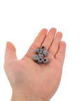 Hand holding 30 Pack Sewing Machine Rubber Needle Rod Covers With Silicone Grommet Plugs For Surface Protection And Precise Fit Pro Grade Replacement Parts For Professional Equipment Maintenance
