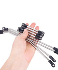 Hand holding link rods from One Tenth Scale Performance Carbon LCG Chassis Kit With Gearbox And Shock Absorbers For RC Crawler.
