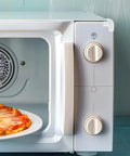 Close-up of white microwave with PVC Corner Protectors For Furniture And Chairs 20 Pack Edge Guards For Safe Desks Cabinets Windows And
