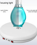 Stunning 25 Cm Electric Rotating Display Stand With Led Light showcasing light effects on a blue bottle, demonstrating clarity and brightness.