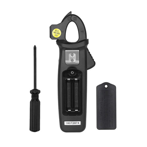 Back view of DC Current Clamp Meter 6000 Counts Digital Multimeter showing battery compartment, with screwdriver and tag