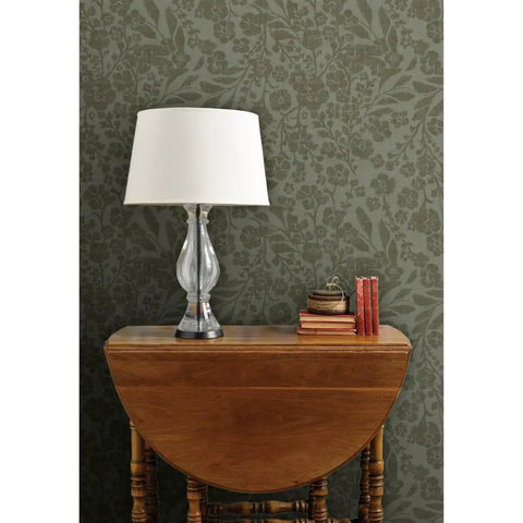 Real Dope Cottage Botanical Wallpaper With Matte Linen Texture And Pvc Free Mix Built For Sturdy Residential Or Commercial Walls That Add A Chill Fresh Vibe To Your Place in a home setting with lamp and wooden table.