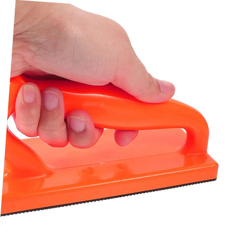 Close-up of hand holding Table Saw Push Block And Push Stick Set for Woodworking, bright orange with rubber pad for safer cutting.