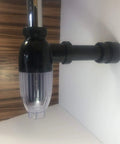 No Mess Money Saving P Trap 2 Pack in black and transparent shown installed under a sink, highlighting its space-saving design.