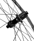 Close-up view of the hub on Fifty Twenty Five Millimeter Disc Brake Tubeless Wheelset For Road Bike 700c With Special Finish No Logos Carbon Fiber Toray T700 Rim Tubeless Ready Dope Shimano Eight Nine Ten Eleven Speed Compatible EN Quality Tested.