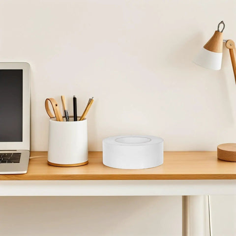 Slick Heavy Duty Double Sided Tape For Quick Fixes And Secure Mounting Reusable Transparent Adhesive Roll on wooden desk.