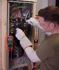 Technician using Datalogging Cat IV True RMS Multimeter With Bluetooth Connectivity at circuit panel for remote data logging.