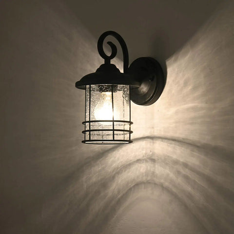 Slim 5.5 Inch Wide Outdoor Wall Light 2 Pack in Textured Black with Seedy Glass illuminated on wall, ETL listed lantern