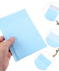 Milk Blue Bubble Mailer Bags 100 Pack Self Sealing Thickened 11x15 Plus 4 Inch Envelopes shown in a hand.