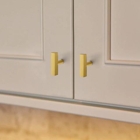 Thirty Hella Sturdy Brushed Brass Cabinet Knobs Featuring Slick Two Inch Square Bar Hardware installed on kitchen cabinets.