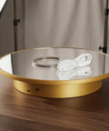 Stunning Mirrored Gold Electric Turntable For Jewelry And Accessories with USB power cable on a wooden table.