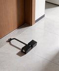 Stainless Steel Hydraulic Door Closer With No Slam Quiet Soft Close And Adjustable Spring Hinge on tile floor by wooden door.