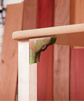 Heavy Duty 8 Pack Foldable Support Brackets Featuring Self Locking Spring Hinge Built Tough Angle Leg Extensions For Tables And Folding Workbenches Quick Release Frame Saves Space, shown mounted on table leg.