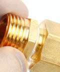 Brass NPT reducer adapter 1/2 in male to 1/4 in female threads, close-up view