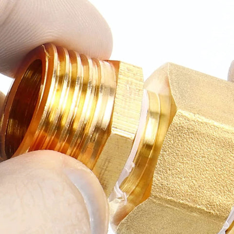 Brass NPT reducer adapter 1/2 in male to 1/4 in female threads, close-up view
