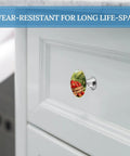Orchard Apple Baskets Round Cabinet Knobs Set Two Pack Durable Stainless Steel Aluminum Alloy Hardware Handles With Vintage Farmhouse Charm For Cabinets And Drawers Ideal For Kitchens And Bedroom Dressers And Entertainment Areas. 1.1in apple basket knob on white cabinet