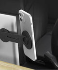 Ultra Thin Aluminum Laptop Phone Holder With Magnetic Quick Mount attached to laptop holding phone in Tesla interior, silver.