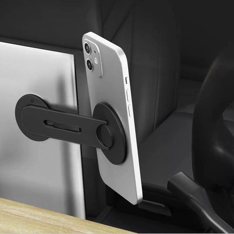 Ultra Thin Aluminum Laptop Phone Holder With Magnetic Quick Mount attached to laptop holding phone in Tesla interior, silver.