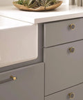 Mergence Cabinet Pull in Matte Black Champagne Bronze, Five And One Sixteenth Inch Center To Center, installed on kitchen drawer
