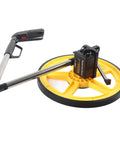 Rugged Workhorse Mechanical Range Measuring Wheel Crushing Miles And Inches Up To Ninety Nine Hundred Ninety Nine Feet with yellow wheel and metal handle.