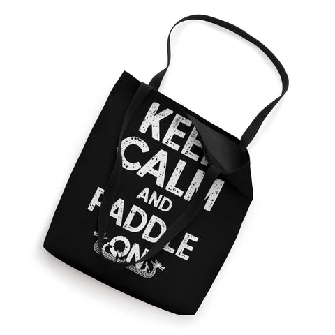 Top view of black Dragon Boat Racing Paddler Tote Bag For Dragonboating Enthusiasts Keep Calm And Paddle On Gear with bold white text.