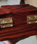 Brass Mini Folding Butt Hinges Set Four Pack, One Inch, installed on a wooden jewelry box, showcasing durability and rust resistance.