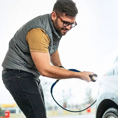 Man using Hella Slick High Performance Water Sprinkler Head with Zinc Alloy Nozzle for Heavy Duty Garden Irrigation and Car Wash.