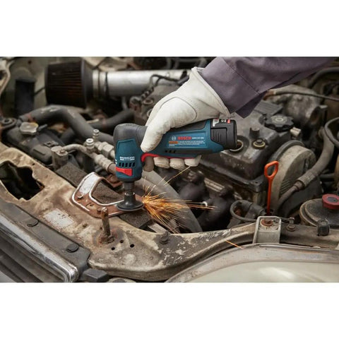 Compact 12 Volt Max Brushless Right Angle Die Grinder With Variable Speed Trigger in use, grinding metal in a car engine bay.
