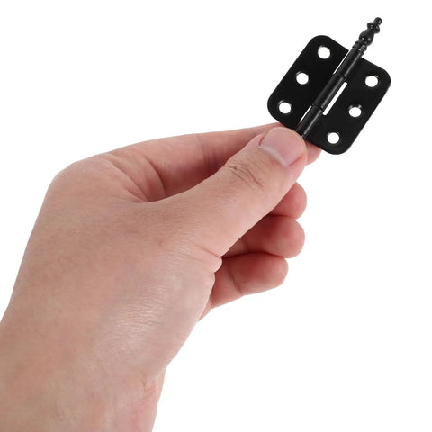 Person holding black 10 Pack Vintage Iron Hinges For Wooden Boxes With Smooth Opening And Wide Mounting Angles