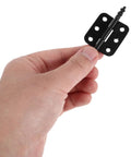 Hand holding Vintage Black Iron Jewelry Box Hinge from the 10-piece set with wide 105 degree opening