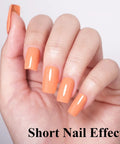 Hand with short nails painted in Coral Orange Gel Nail Polish 10ml HEMA Free UV LED Cure Soak Off Long Lasting Summer Formula