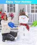 Woman and snowman with Beast Beach Sand Shovels For Kids And Adults, 16 Inch Wooden-Handled Spades in snow